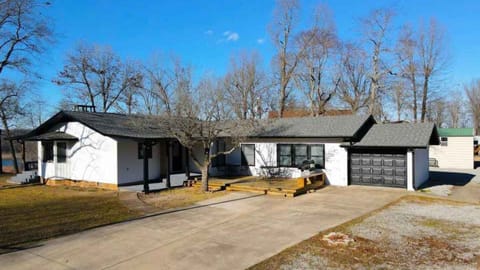 Driveway & kitchen entrance. Large area for parking/playing. Fire pit in back.