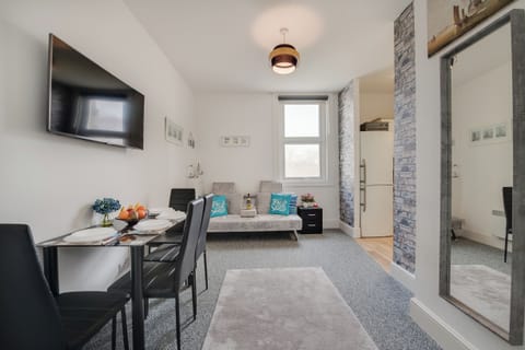 Living Room Retreat: Bright and airy space with stylish decor, perfect for relaxation or dining!