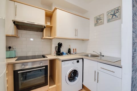 Kitchen: Modern design with sleek appliances and stylish decor for perfect culinary adventures!