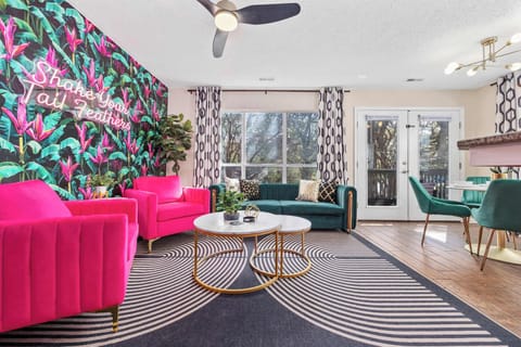 Open kitchen, living room and dining area with smart TV and doors leading to private patio