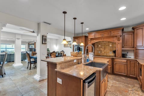 Open-concept kitchen flows seamlessly into the living and dining spaces—ideal for entertaining during your lakefront stay.
