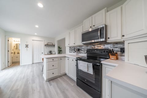 The kitchen is well stocked with pots, pans, utensils, crock pot, griddle.