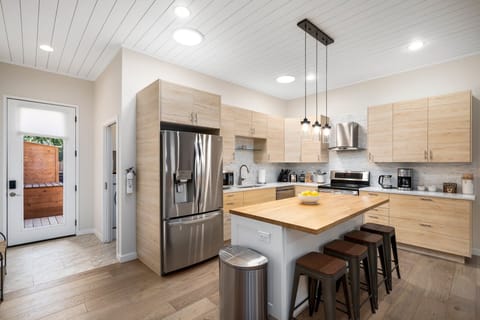 {Kitchen} Fully stocked kitchen with modern appliances, coffee essentials, spices, and more.