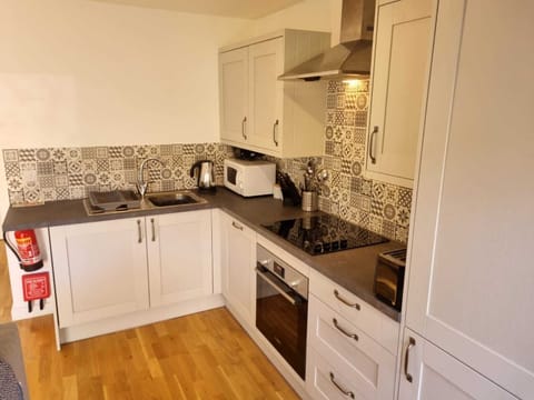Modern kitchen with washing machine, dishwasher, fridge freezer, oven, microwave