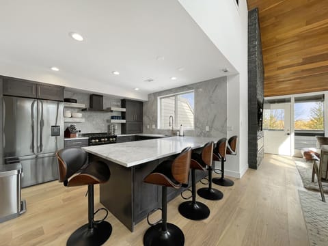 The kitchen bar adds seating for five more, ensuring everyone has a spot to gather for breakfast or a casual snack.