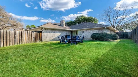 Huge fenced back yard equipped with a gas grill and additional covered seating 