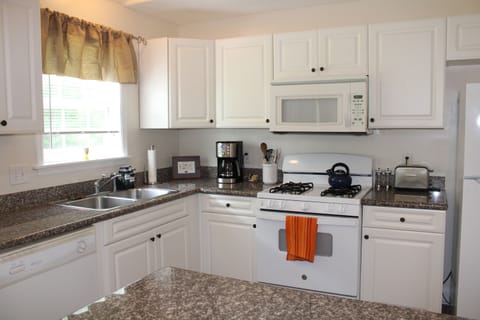 Beautiful kitchen with every utensil , stocked by a professional chef.