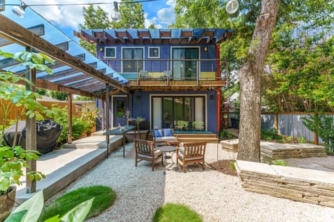 Backyard with ample seating, propane grill and string lights
