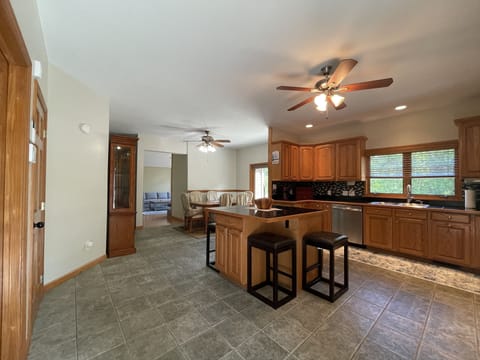 Large kitchen w/ all the appliances/cooking utensils - island with 4 bar stools