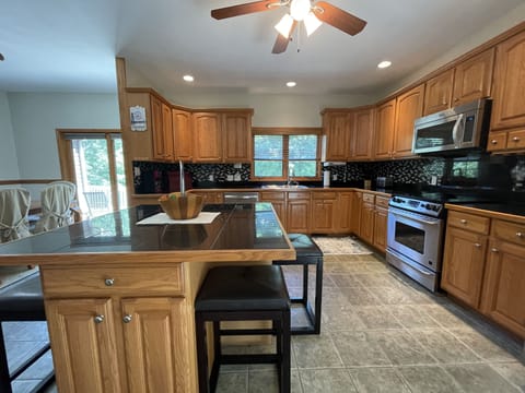 Large kitchen w/ all the appliances/cooking utensils - island with 4 bar stools