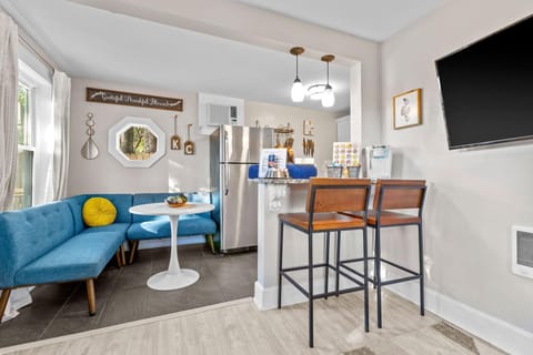 Bright and cozy dining area with a built-in bench, modern lighting, and quick access to the kitchen — perfect for meals before exploring Midtown, Westport, or the Nelson-Atkins Museum