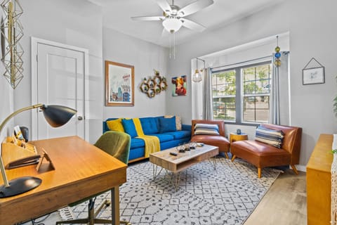 Bright and stylish living room featuring colorful mid-century décor—just 1 mile from the Country Club Plaza and steps from free KC Streetcar access.