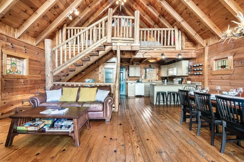 The main living area includes a fully equipped kitchen, large dining table, and many games on shelves for a fun game night!