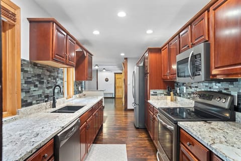 This fully equipped kitchen features modern appliances and generous counter space — perfect for preparing meals during your stay.