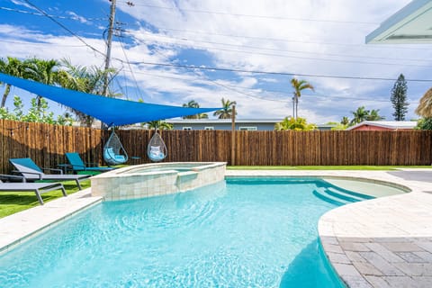 Our lovely heated pool and hot-tub. But Don't miss relaxing under the TIKI