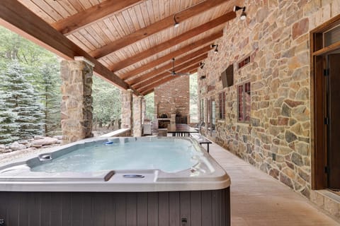 Huge hot tub on the covered stone patio
