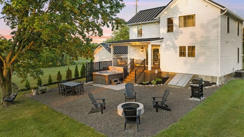 Backyard with pea gravel patio, hot tub, and firepit