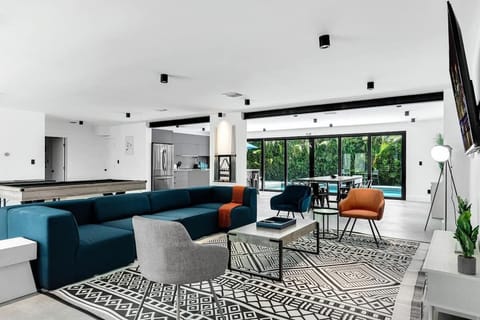 Bright, modern poolside retreat with open‑concept living, stylish decor, and floor‑to‑ceiling windows. Perfect vacation rental for families and groups looking for a relaxing Airbnb stay with comfort, space, and resort‑style vibes