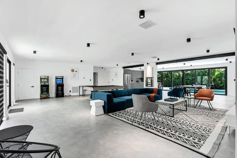 "Expansive open-concept space with modern kitchen, stylish lounge, and indoor-outdoor flow. This luxury vacation rental offers contemporary design perfect for entertaining families and groups. Resort-style Florida living at its finest!"