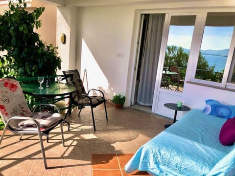 Apartment terrace with sofa, table and chairs