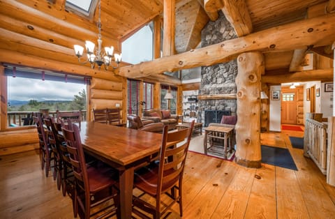 Dining area with room for 12 people and large fireplace in background
