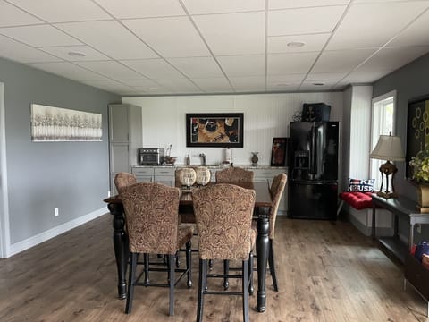 Lower level kitchen and dining accessing patio, hot tub, and pool.