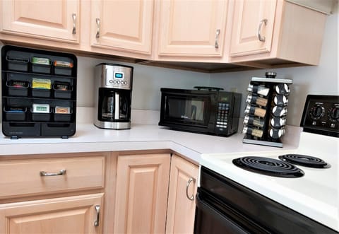 Cuisinart coffee maker, tea rack with a dozen assorted teas, spice rack, coffee