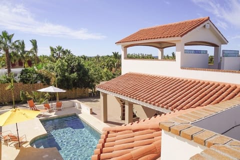 View from the upstairs bedroom of the pool area and the open-air pergola.