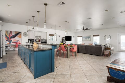 Socialize with others in the living room while cooking and eating