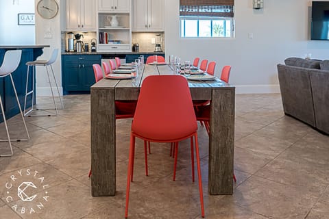 Rustic wooden dining table seats 10. Additional 6-8 can fit at bar.