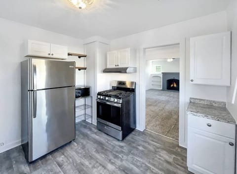 Kitchenette area includes fridge, gas oven/stove, microwave, portable dishwasher