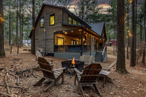 Gather around the inviting outdoor firepit, where flickering flames and crackling wood create a cozy ambiance, perfect for sharing stories, roasting marshmallows, and making cherished memories