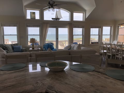 Large open kitchen, living, and dining area with incredible ocean views.