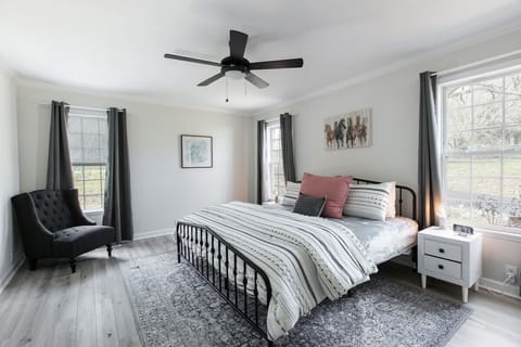 master bedroom with king-size bed, walk-in closet, attached bathroom and 6 drawer dresser