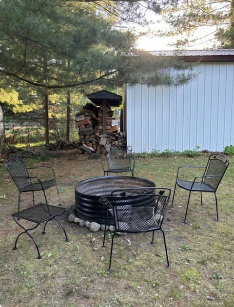 Fire pit in backyard with seasoned local firewood. Do Not bring outside wood.