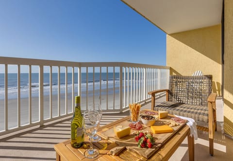 Unwind on the oceanfront balcony with panoramic beach views — perfect for morning coffee or evening wine.