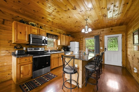 Fully equipped kitchen with island and additional bar seating.