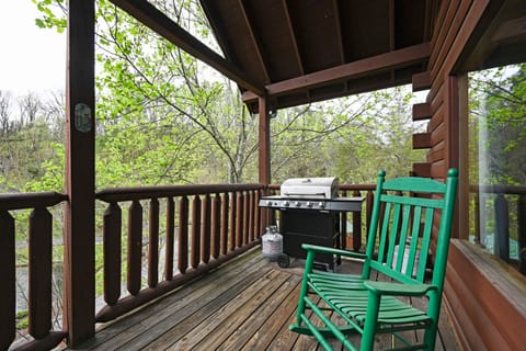 A propane grill and rocking chairs on the deck.