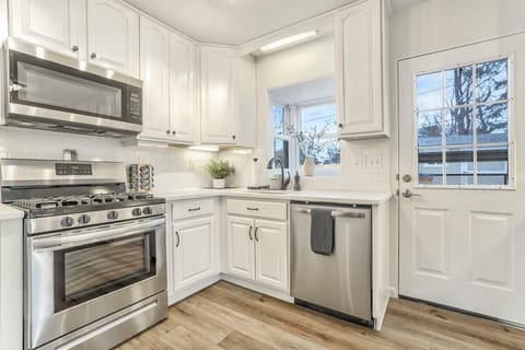 Large, spacious, Fully-stocked kitchen with everything you could need from pots, pans, mixing bowls, wine bottle opener, spices, measuring cups, measuring spoons, and so much more!