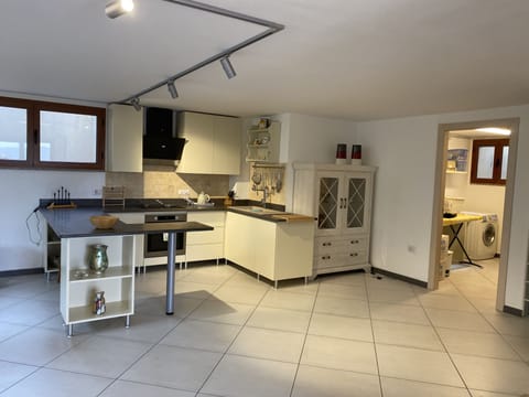 Fully equipped kitchen leading into utility room 