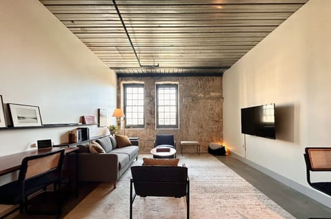 Spacious and light-filled living room with dedicated workspace and a dining table/flex workspace