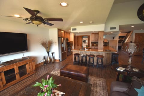 Spacious and comfortable living room with flat screen television.