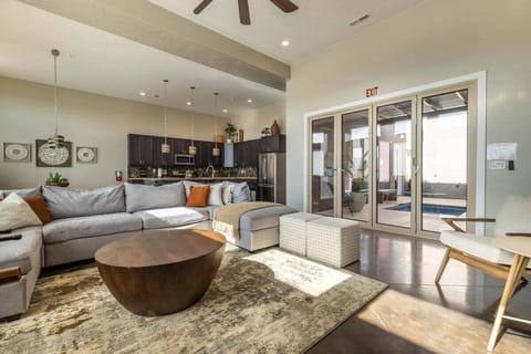 Relax in this spacious living room, complete with a plush sectional that offers plenty of seating. The flat-screen TV is ideal for entertainment, while the foosball table adds a touch of excitement and a playful ambiance.