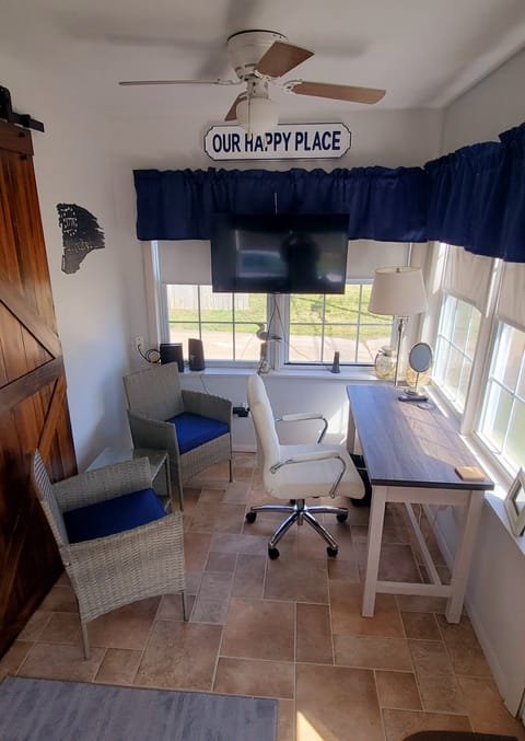 Office/sunroom with new desk, chairs and 40" smart tv