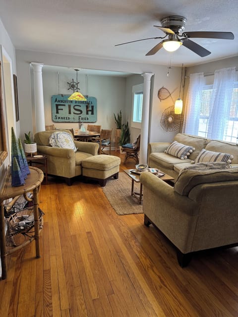 Living room with large tv and 4 seated table with games & puzzles