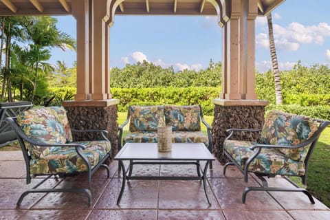 Unwind in your private tropical seating area, where vibrant cushions invite relaxation while you soak in the lush garden views.