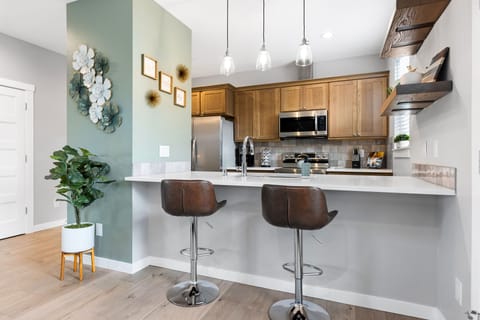 Brand new, fully stocked kitchen with bar stool seating. 
