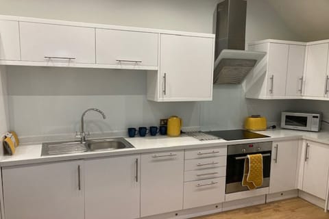 Kitchen with microwave, fridge, washing machine