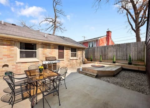 Backyard with table, perfect for dining outside.