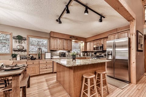 Spacious, cooking kitchen ready for your cabin experience.  Every tool is ready for your use, gas-top stove, fridge with ice maker and filtered water to utensils, pots/pans, bowls, cooking tools, spices and more.